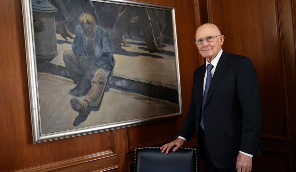 President Oaks beside “The Forgotten Man” painting by Maynard Dixon.